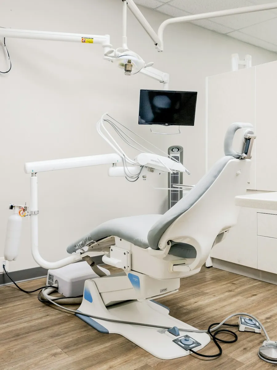 Bright, tidy dental treatment room with a dentist's chair